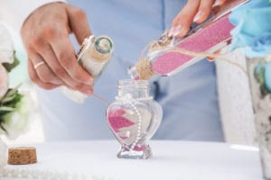 Bride,And,Groom,Pouring,Colorful,Different,Colored,Sands,Into,The