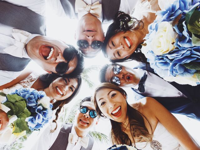 Look,From,Below,At,Newlyweds,And,Friends,Hugging,Outside