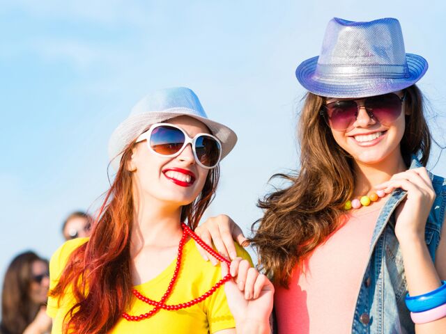 Two,Young,Girlfriends,Having,Fun,On,The,Background,Of,Blue