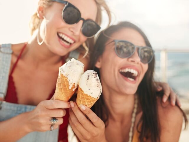 Two,Young,Female,Friends,Having,Fun,And,Eating,Ice,Cream.
